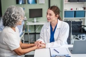 Beautiful medical professional speaking with an older patient